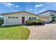 Inviting single-story home boasting lush landscaping and a brick paver driveway at 547 Suwanee Cir, Tampa, FL 33606