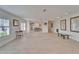 Expansive living room with neutral tile, recessed lighting and large windows with plantation shutters at 547 Suwanee Cir, Tampa, FL 33606