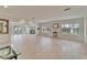 Bright living room featuring neutral tile, plantation shutters, and an open layout at 547 Suwanee Cir, Tampa, FL 33606