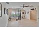 Bright living room features tile floors, a ceiling fan, and a collection of fishing rods and reels at 547 Suwanee Cir, Tampa, FL 33606