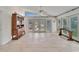 Spacious living room with tiled floors and glass doors to the outside at 547 Suwanee Cir, Tampa, FL 33606