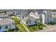 Aerial view of a community of modern white homes with lush green lawns and palm trees at 5932 Red Mangrove Ln, Bradenton, FL 34210