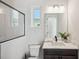 Bright bathroom featuring a shower with a black frame, a toilet, and a modern vanity with a white countertop at 5932 Red Mangrove Ln, Bradenton, FL 34210