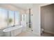 Bathroom featuring a freestanding tub, a frameless shower, and access to a toilet at 5932 Red Mangrove Ln, Bradenton, FL 34210