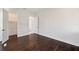 Spacious bedroom with hardwood floors, white walls, base molding, and a walk-in closet at 5932 Red Mangrove Ln, Bradenton, FL 34210
