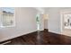 Bedroom featuring hardwood floors, a window, and a door to the walk-in closet and the hallway at 5932 Red Mangrove Ln, Bradenton, FL 34210