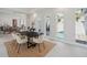 Modern dining room featuring a black table, neutral chairs, and views of the pool at 5932 Red Mangrove Ln, Bradenton, FL 34210