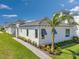 Charming single-story home showcasing a lush front yard with a beautiful palm tree and well-maintained landscaping at 5932 Red Mangrove Ln, Bradenton, FL 34210