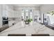 Bright kitchen featuring an oversized island, modern appliances, and seamless access to outdoor spaces for easy entertaining at 5932 Red Mangrove Ln, Bradenton, FL 34210