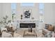 Bright living room featuring a modern fireplace, large windows and stylish decor at 5932 Red Mangrove Ln, Bradenton, FL 34210