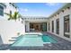 Outdoor oasis featuring a private pool with a view into the main bedroom with an open and connected indoor-outdoor living space at 5932 Red Mangrove Ln, Bradenton, FL 34210