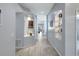 Elegant hallway with light gray walls, modern wood-look tile floors and decorative alcoves at 6004 Martinglade Pl, Lithia, FL 33547