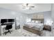 Relaxing main bedroom with a comfortable bed, natural lighting, and desk area at 6004 Martinglade Pl, Lithia, FL 33547