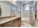 Well-lit bathroom featuring granite countertops, a shower-tub combination, and modern fixtures at 624 Winterside Dr, Apollo Beach, FL 33572