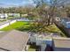 Expansive lot with mature trees, a verdant lawn, and white fencing highlights the potential of the single story home at 8025 N Gomez Ave, Tampa, FL 33614