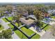 A single story home features a well-manicured lawn and a white fence at 8025 N Gomez Ave, Tampa, FL 33614