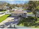 An aerial view showcases a single story home in a lush green yard with a white fence at 8025 N Gomez Ave, Tampa, FL 33614