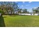 Expansive backyard featuring a large grassy area enclosed by a white fence at 8025 N Gomez Ave, Tampa, FL 33614
