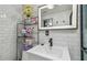 Bathroom featuring white subway tile walls, floating shelves, and a modern sink vanity at 8025 N Gomez Ave, Tampa, FL 33614