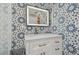 Stylish bathroom featuring a mosaic tile accent wall, modern vanity, and bright lighting at 8025 N Gomez Ave, Tampa, FL 33614