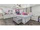 Spacious bedroom with modern furniture, ample closet space, and grey wood flooring at 8025 N Gomez Ave, Tampa, FL 33614