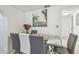 Modern dining room featuring a glass table and elegant seating arrangement at 8025 N Gomez Ave, Tampa, FL 33614