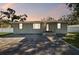 Charming single-story home featuring a brick facade, a well-manicured lawn, and a welcoming front entrance at 8025 N Gomez Ave, Tampa, FL 33614