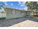 Charming single-story home with a brick paver patio leading to a covered entryway at 8025 N Gomez Ave, Tampa, FL 33614