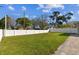 Spacious front yard with white fencing and a glimpse of the home's exterior at 8025 N Gomez Ave, Tampa, FL 33614