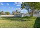 Well-kept front yard showcasing the home's facade and surrounding landscape at 8025 N Gomez Ave, Tampa, FL 33614