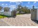 Gated entrance to a large backyard, featuring brick pavers and lush greenery at 8025 N Gomez Ave, Tampa, FL 33614