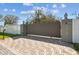 Wide gated entrance with brick pavers, providing secure access to the property at 8025 N Gomez Ave, Tampa, FL 33614