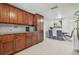 Bright eat-in kitchen with custom wood cabinets, granite countertops, and a dining area at 8025 N Gomez Ave, Tampa, FL 33614