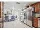 Modern eat-in kitchen with stainless steel appliances, granite countertops, and a dining area at 8025 N Gomez Ave, Tampa, FL 33614