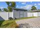 Backyard shed with brick pavers, offering extra storage space and convenience at 8025 N Gomez Ave, Tampa, FL 33614