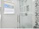 Modern shower with glass door, hexagon tile walls, and mosaic tile accent at 8025 N Gomez Ave, Tampa, FL 33614