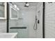 Close-up of modern subway tile shower with glass door and black fixtures at 8025 N Gomez Ave, Tampa, FL 33614