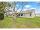 The backyard boasts a large, mature tree and a screened-in lanai for relaxing outdoors at 9402 Stonewall Ln, New Port Richey, FL 34655