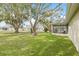 Spacious backyard with mature trees and a screened-in lanai perfect for entertaining at 9402 Stonewall Ln, New Port Richey, FL 34655