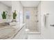 Bathroom featuring granite countertops and a tiled walk-in shower at 9402 Stonewall Ln, New Port Richey, FL 34655