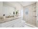 A modern bathroom featuring granite countertops and a tiled walk-in shower at 9402 Stonewall Ln, New Port Richey, FL 34655
