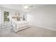Bright bedroom with neutral paint, plush carpet, and natural light from the large windows at 9402 Stonewall Ln, New Port Richey, FL 34655