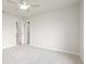 Bright bedroom features neutral paint, plush carpet, and a ceiling fan at 9402 Stonewall Ln, New Port Richey, FL 34655
