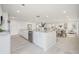 Open-concept kitchen featuring island, stainless steel appliances, and abundant natural light at 9402 Stonewall Ln, New Port Richey, FL 34655