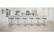 Eat-in kitchen with bar stool seating, stainless steel appliances, white cabinetry, and quartz countertops at 9402 Stonewall Ln, New Port Richey, FL 34655