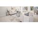Bright, open-concept living space featuring modern decor, neutral tile flooring, and abundant natural light at 9402 Stonewall Ln, New Port Richey, FL 34655