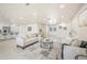 Bright, open-concept living space featuring modern decor, neutral tile flooring, and abundant natural light at 9402 Stonewall Ln, New Port Richey, FL 34655