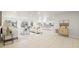 Bright, open-concept living space featuring modern decor, neutral tile flooring, and abundant natural light at 9402 Stonewall Ln, New Port Richey, FL 34655