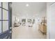 Bright, open-concept living space featuring modern decor, neutral tile flooring, and abundant natural light at 9402 Stonewall Ln, New Port Richey, FL 34655