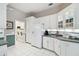 Bright kitchen featuring white cabinets, stainless appliances, and tiled floors at 9812 Reynosa Dr, New Port Richey, FL 34655